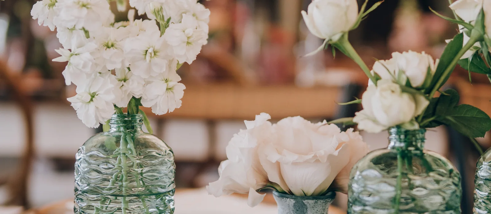 Floral table detail with soft white blooms